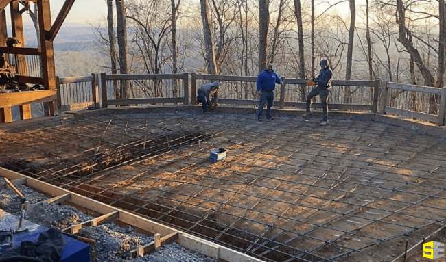 3 people on the site, laying the outlines down to pour concrete