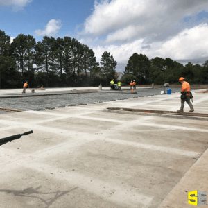 A group of construction workers working on a large concrete pour