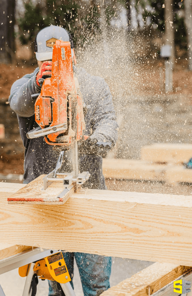 A person using a band saw to cut a piece of wood