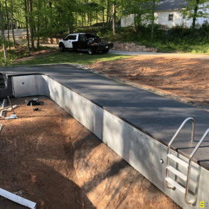 The finished concrete outline of an in ground pool