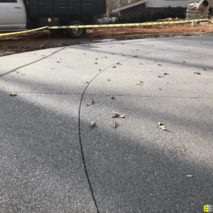 A closeup of a concrete driveway in progress