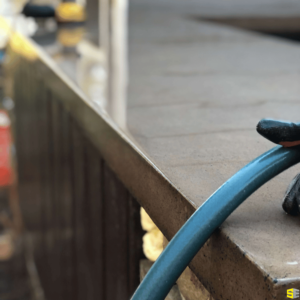 The close up of a finished concrete countertop with a hose resting against it