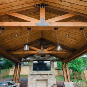 A closer look at the frame of an outdoor gazebo roof, with hanging tea light like lights