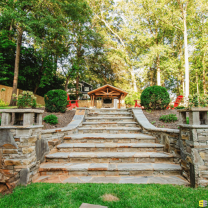 A set of concrete steps with landscaping surrounding it, leading to an outdoor gazebo