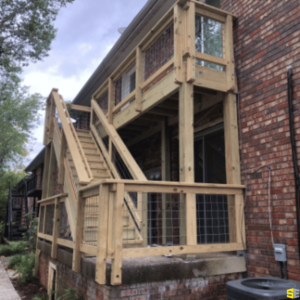 The finished product of a small outdoor patio, with steps from the main floor leading to the top floor.