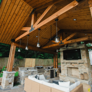 A focus on drop tea lights attached to the frame of a finished outdoor gazebo