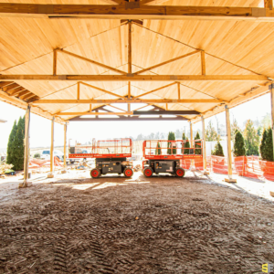 A picture with two lifts side by side, constructing an outdoor wooden gazebo