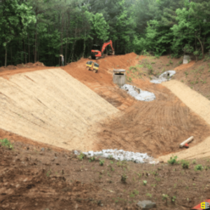 Construction of a drainage area to the side of a dirt road