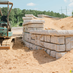 A retaining wall being built, a tractor off to the side